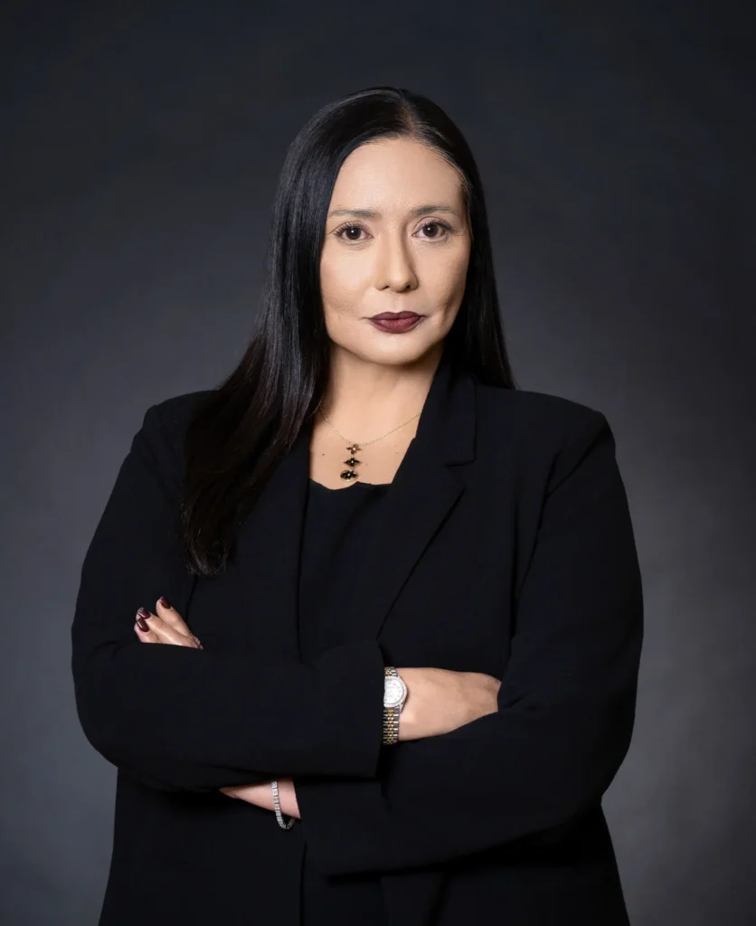 Professional headshot of Janelle Rollo, Summit Conflict Resolution mediator, smiling in a black blazer and pink top for family law mediation.