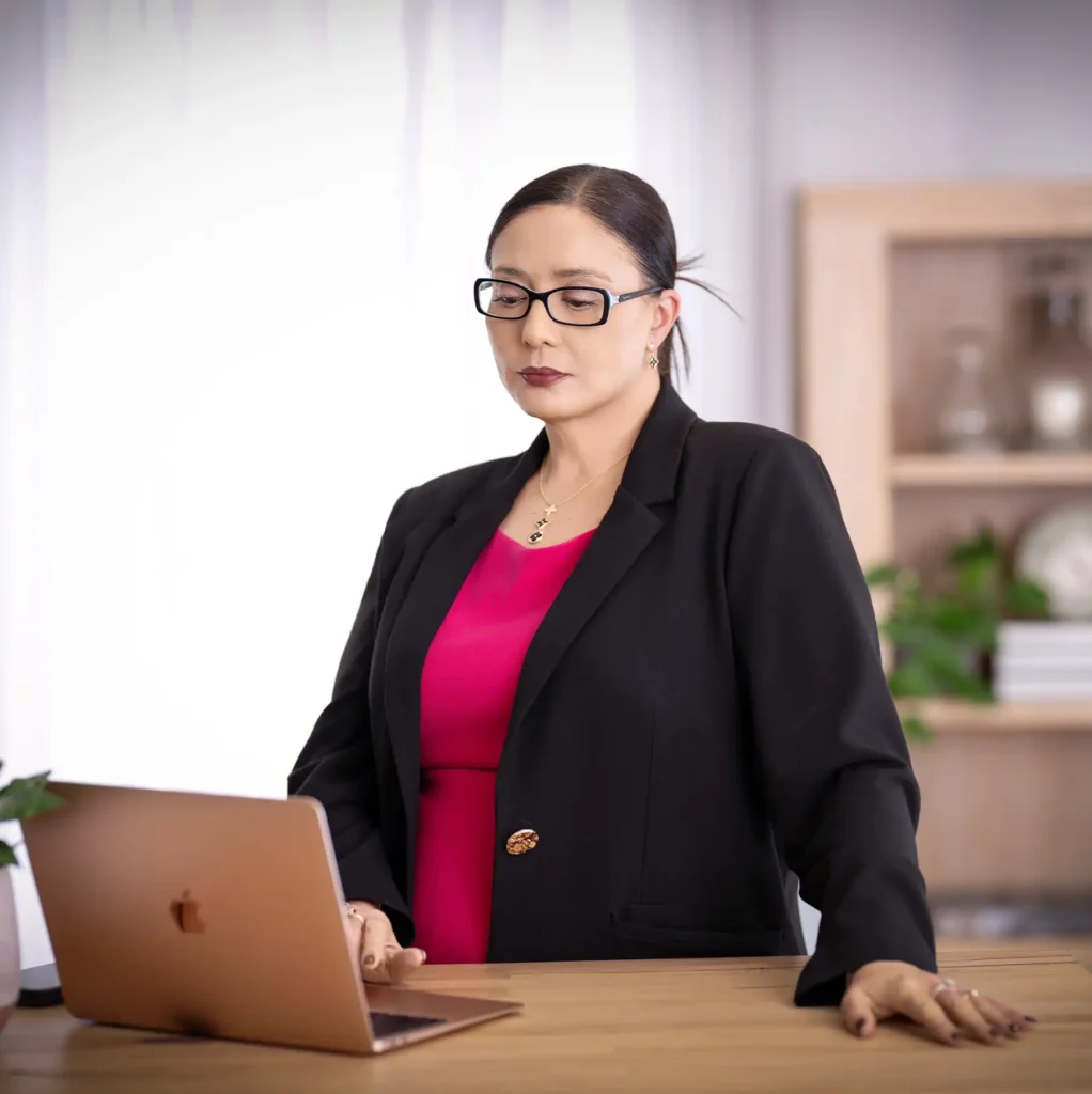Janelle Rollo, Summit Conflict Resolution mediator, working at a desk with a laptop for property dispute mediation.